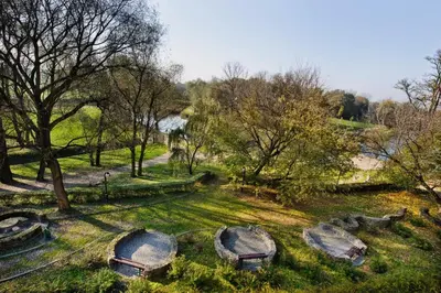 a park with a bunch of rocks in the grass at Dworek Skawiński in Skawina