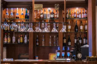 a bar with many bottles of alcohol on shelves at Dworek Skawiński in Skawina