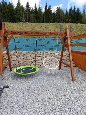 a playground with a wooden ramp and a building at Czesławka in Zawoja
