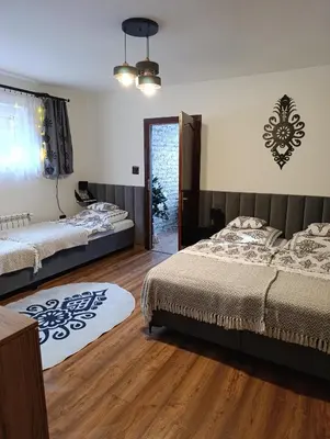 a bedroom with a bed and a painting of a road at Czesławka in Zawoja