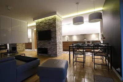 a living room with a table and a fireplace at Apartament 