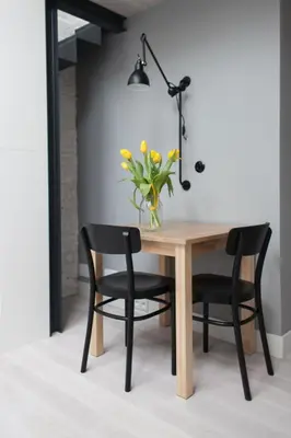 a dining room table and chairs with a vase of flowers at Modern Apartment46 / Kazimierz in Kraków