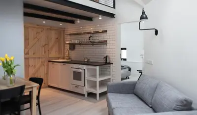 a living room with a couch and a kitchen at Modern Apartment46 / Kazimierz in Kraków