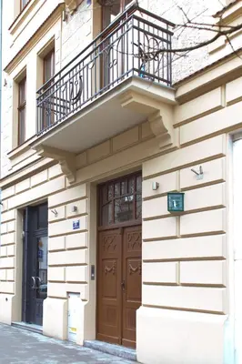 a building with a balcony and a wooden door at Modern Apartment46 / Kazimierz in Kraków