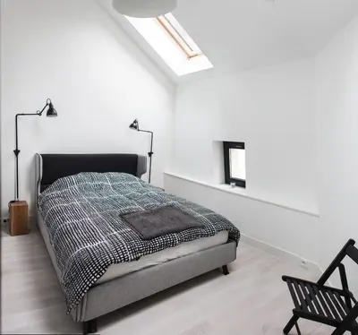 a white bedroom with a bed and a chair at Modern Apartment46 / Kazimierz in Kraków