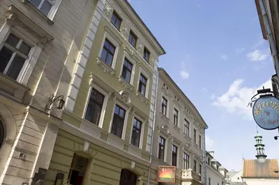 a large building with a sign in front of it at Pokoje Gościnne Poselska 20 in Kraków