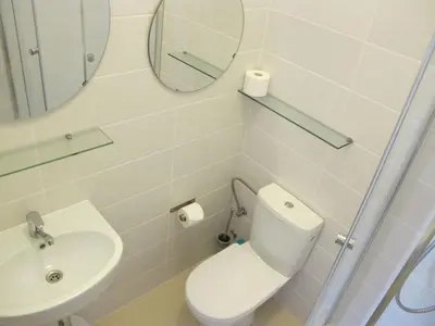 a bathroom with a toilet and a sink and a mirror at Pokoje Gościnne Poselska 20 in Kraków