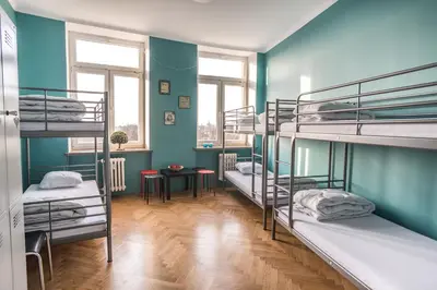 a room with three bunk beds in it at Bubble Hostel in Kraków