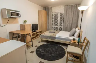 a small room with a bed and a desk and a television at Bubble Hostel in Kraków