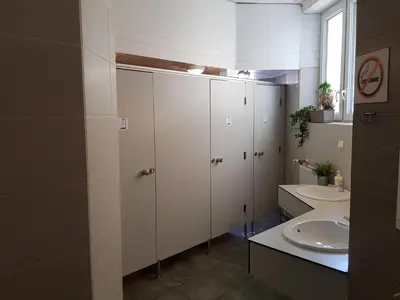 a bathroom with white cabinets and a sink at Bubble Hostel in Kraków
