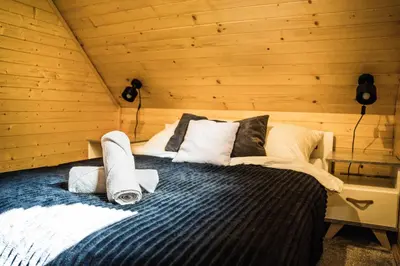 a bedroom with a bed in a wooden room at Chata 