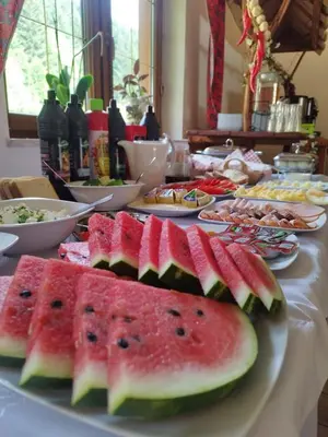 a table with plates of watermelon slices on it at Chata 