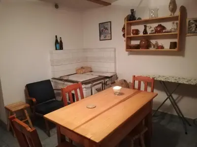a dining room with a wooden table and chairs at Pokoje Gościnne Lalaj in Bolęcin