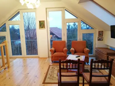 a living room with two chairs and a table at Pokoje Gościnne Lalaj in Bolęcin