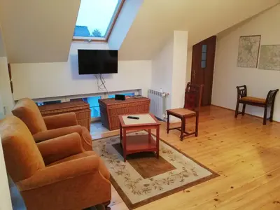 a living room with a couch and a tv at Pokoje Gościnne Lalaj in Bolęcin
