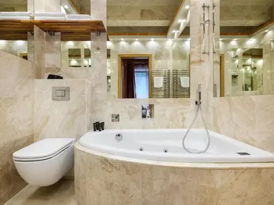 a bathroom with a tub and a toilet and a sink at Krowoderska Apartments in Kraków