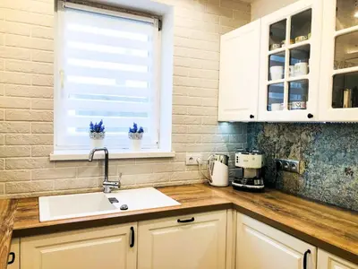 a kitchen counter with a sink and a window at Apartament LUSCINIA z 2 sypialniami in Kraków