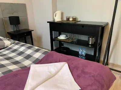 a room with a bed and a table with water bottles at Arkada Wadowice in Wadowice