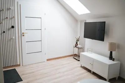 a white room with a television and a white door at Arkada Wadowice in Wadowice