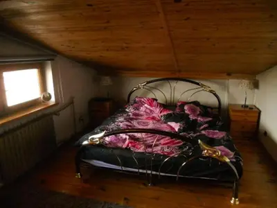 a bed in a room with a wooden ceiling at Apartament na Fatimskiej in Kraków