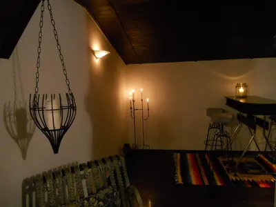 a room with a chandelier and a table with a couch at Apartament na Fatimskiej in Kraków