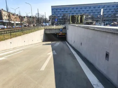 an empty tunnel in a city with a building at Tenement Apartment 90m2 City Center in Kraków