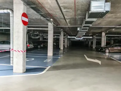 an empty parking garage with cars parked in it at Tenement Apartment 90m2 City Center in Kraków