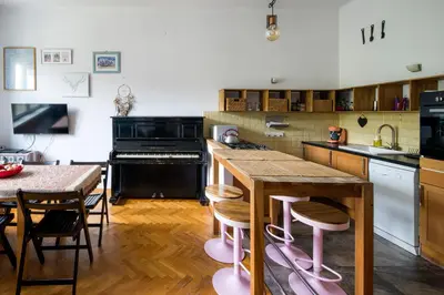 a kitchen with a table and a counter top at Tenement Apartment 90m2 City Center in Kraków