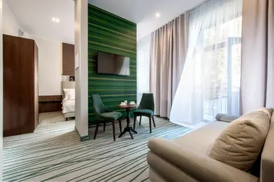 a living room with a couch and a table at Plaza Boutique Hotel in Kraków