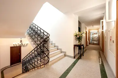 a staircase in a house with a stair case at Plaza Boutique Hotel in Kraków