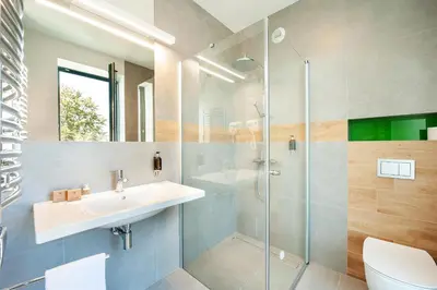 a bathroom with a sink and a shower at Plaza Boutique Hotel in Kraków