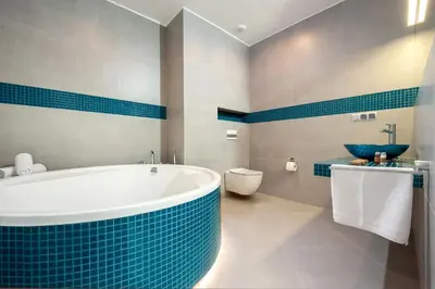 a bathroom with a tub and a toilet and a sink at Plaza Boutique Hotel in Kraków