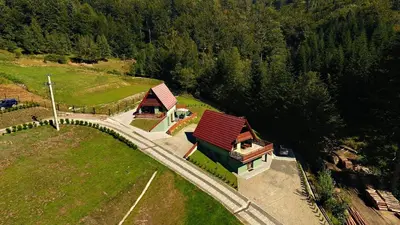 a house on a hill with a view of a forest at Domki Beskid in Rzyki