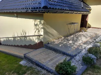 a house with a blue roof and some stairs at Michałowice Noclegi u Anety in Michałowice