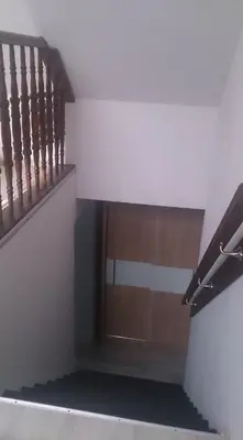 a stairway with a wooden railing and a stair case at Michałowice Noclegi u Anety in Michałowice