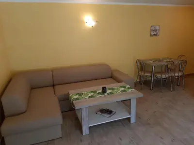 a living room with two beds and a table at Domki Beskid in Rzyki