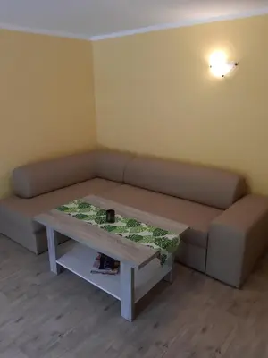a dining room with a table and chairs and a kitchen at Domki Beskid in Rzyki