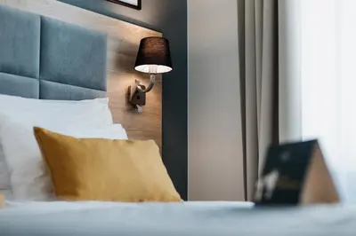 a hotel room with a bed with a lamp on it at Hotel 32 Kraków Old Town in Kraków