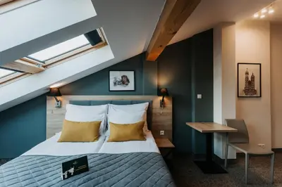 a bedroom with a bed and a desk at Hotel 32 Kraków Old Town in Kraków