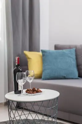 a table with a bottle of wine and two glasses at Krakow B&B - Old Town in Kraków