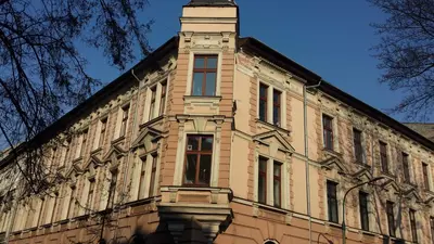 a building with a clock tower on top of it at Krakow B&B - Old Town in Kraków