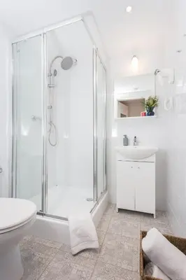 a bathroom with a shower and a toilet and a sink at Krakow B&B - Old Town in Kraków