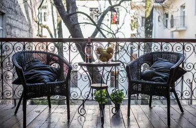 two chairs and a table on a balcony at Krakow B&B - Old Town in Kraków