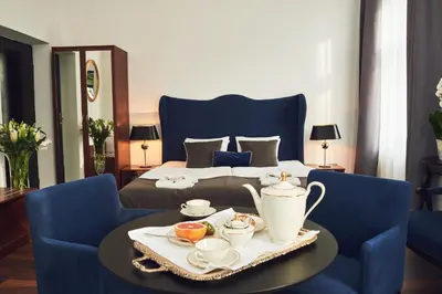a bedroom with a bed and a table with a tea set at Shalom Kazimierz in Kraków