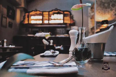 a table with a bottle of wine and a glass at Shalom Kazimierz in Kraków
