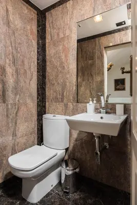 a bathroom with a toilet and a sink at Orlowska Townhouse Apartments in Kraków
