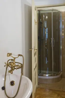 a bathroom with a sink and a shower at Orlowska Townhouse Apartments in Kraków