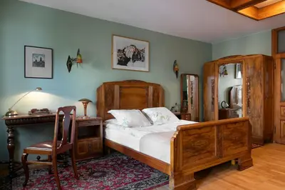 a bedroom with a bed and a desk and a chair at Orlowska Townhouse Apartments in Kraków