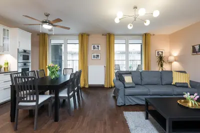 a living room with a couch and a table at Krakow Central Apartment Free Parking in Kraków