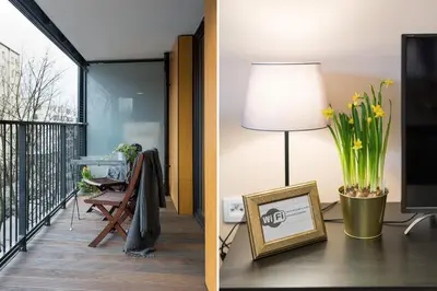 a living room with a television and a table with a lamp at Krakow Central Apartment Free Parking in Kraków